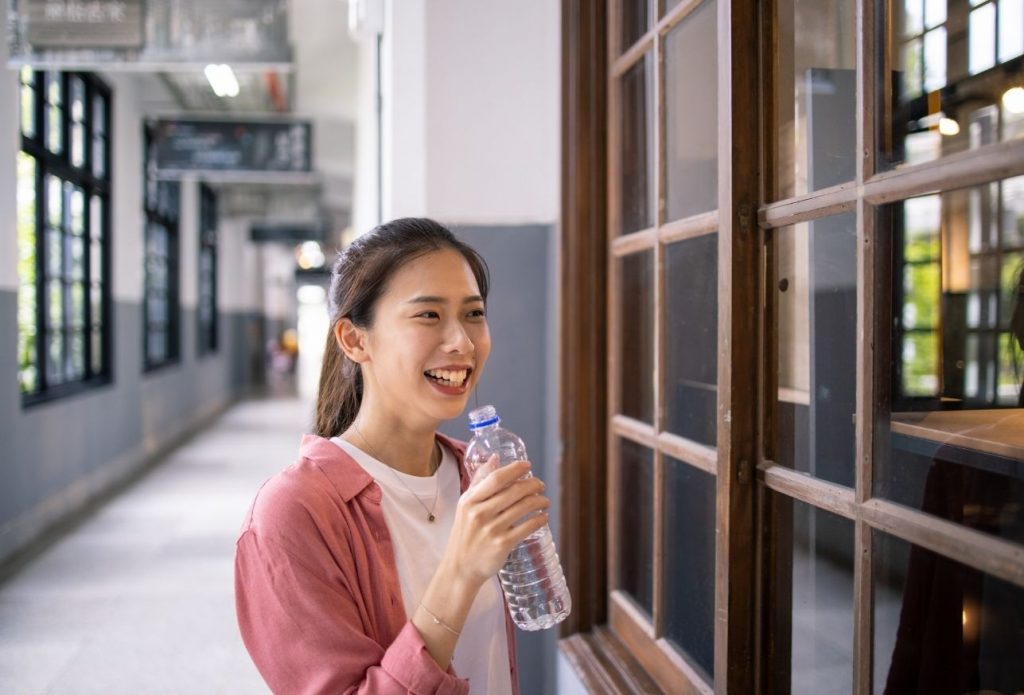 student drinks filtered bittle water in school