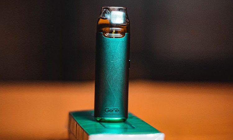 a turquoise colored vape device on top of its merch box